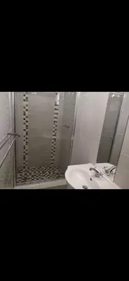 a bathroom with a sink and a shower with a mirror at Soteria House in Kempton Park