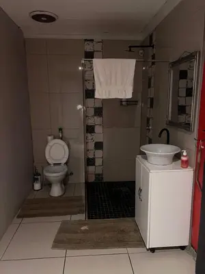 a bathroom with a toilet and a sink at 17 Byvanger Luxury Room 6 in Centurion