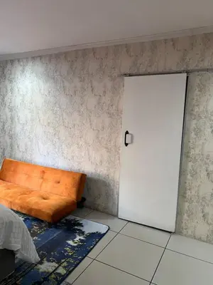 a room with a couch and a door at 17 Byvanger Luxury Room 6 in Centurion