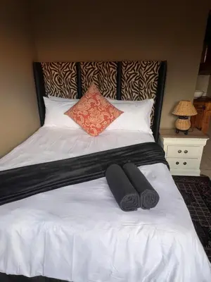 a bed with two pillows on top of it at MorningMist Boutique 27 Room 5 in Centurion