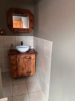 a bathroom with a sink and a mirror on the wall at MorningMist Boutique 27 Room 5 in Centurion