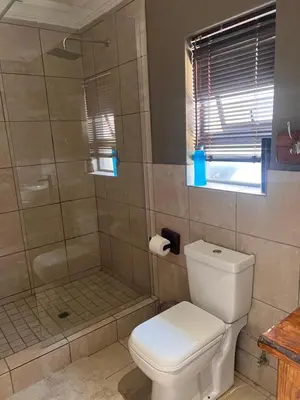 a bathroom with a toilet and a shower at MorningMist Boutique 27 Room 5 in Centurion