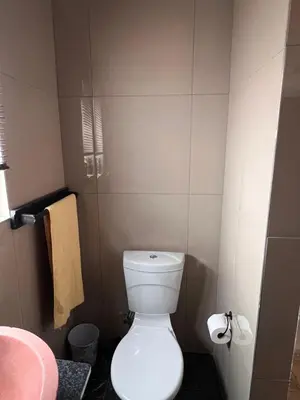 a small bathroom with a toilet and towels at Morningmist Boutique 27 Room 3 in Centurion