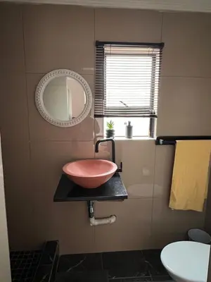 a bathroom with a bowl sink and a mirror at Morningmist Boutique 27 Room 3 in Centurion