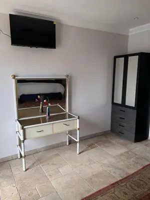 a table in a room with a tv on a wall at MorningMist Boutique 27 Room 2 in Centurion