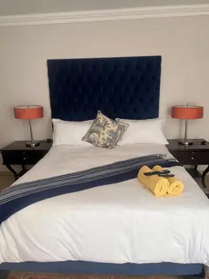 a bed with two towels on it with two lamps at MorningMist Boutique 27 Room 2 in Centurion