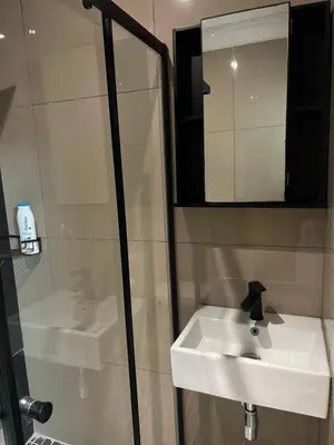 a bathroom with a white sink and a mirror at MorningMist Boutique 27 Room 4 in Centurion
