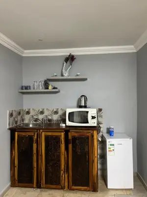 a kitchen with a microwave and a refrigerator at MorningMist Boutique 27 Room 4 in Centurion