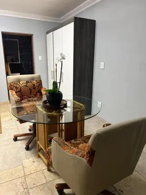 a living room with a glass table and chairs at MorningMist Boutique 27 Room 4 in Centurion