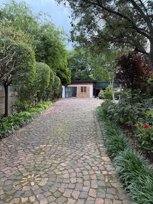 a cobblestone driveway in front of a house at Tambo Touchdown Suites in Benoni