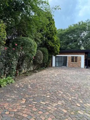 a brick driveway in front of a garage at Tambo Touchdown Suites in Benoni