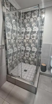 a shower stall in a bathroom with sheep wallpaper at Ekuhlaleni Room 6 in Pretoria