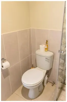 a bathroom with a toilet and a shower at Ekuhlaleni Room 6 in Pretoria