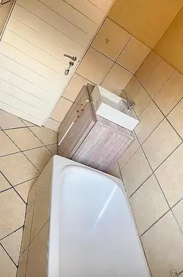 a bathroom with a toilet in a tiled floor at 2 Heron street,stonenge vidago 6 in Nelspruit