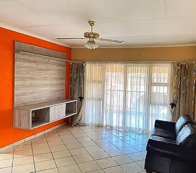 a living room with a couch and a tv at 2 Heron street,stonenge vidago 6 in Nelspruit