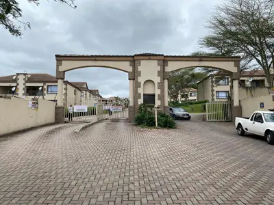 a building with an arch in a parking lot at 2 Heron street,stonenge vidago 6 in Nelspruit