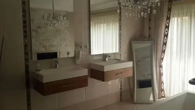 a bathroom with two sinks and a large mirror at Eagle Rock Executive Guest House in Kempton Park