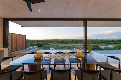 a dining room with a glass table and chairs at Shira Lodge Africa