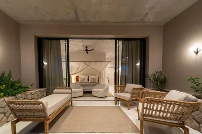 a living room with a couch and chairs and a bed at Shira Lodge Africa