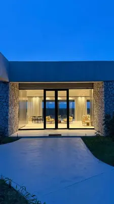 a house with large glass doors and a patio at Shira Lodge Africa
