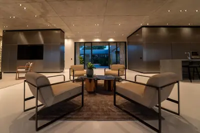 a lobby with chairs and a table and a television at Shira Lodge Africa