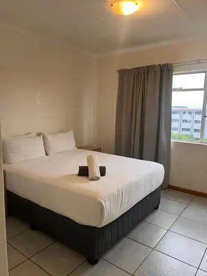 a large bed in a room with a window at Menlyn Place 512 in Pretoria