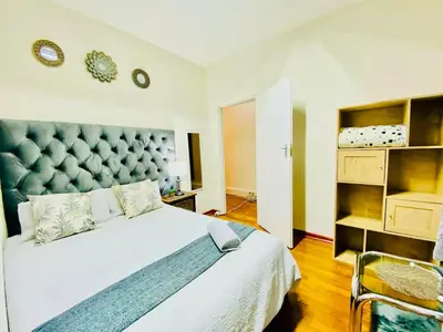 a bedroom with a large bed with a large headboard at Siena Sun Celebration House Party friendly noise tolerant in Midrand