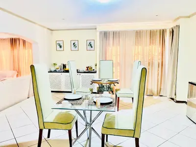 a dining room with a table and chairs at Siena Sun Celebration House Party friendly noise tolerant in Midrand
