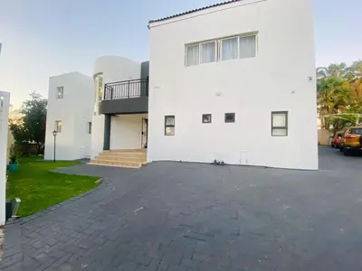 a white building with a parking lot in front of it at Siena Sun Celebration House Party friendly noise tolerant in Midrand