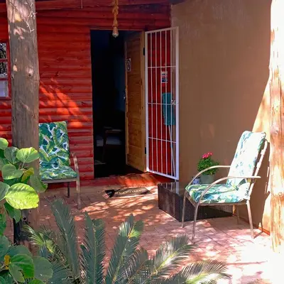 two chairs sitting on the porch of a house at 6 on First Self catering in Pretoria
