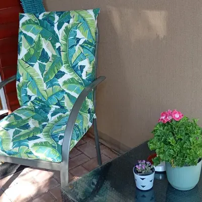 a chair sitting on a table with two potted plants at 6 on First Self catering in Pretoria