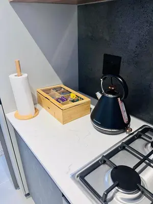 a kitchen counter top with a stove and a box at The Aura at Castle Gate in Pretoria