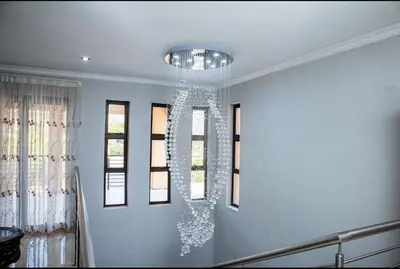 a chandelier hanging from the ceiling in a room at Tindlovu GuestT House in Nelspruit