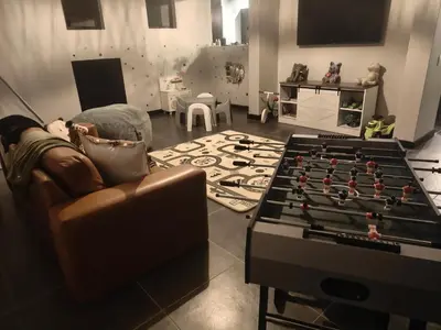 a living room with a couch and a foos ball at Shalom Mountain & Fly-Fishing Lodge in Dullstroom