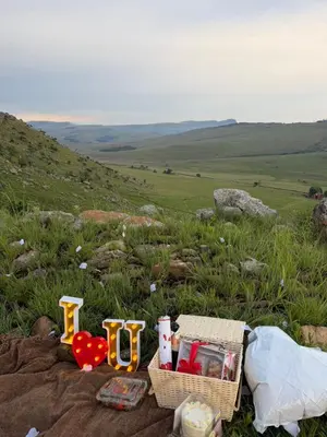 a picnic with a basket and other items on a hill at Shalom Mountain & Fly-Fishing Lodge in Dullstroom