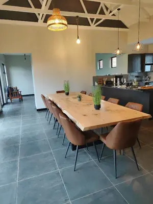 a dining room with a wooden table and chairs at Shalom Mountain & Fly-Fishing Lodge in Dullstroom