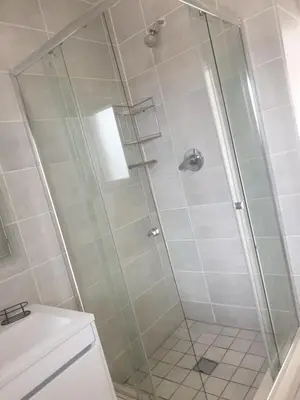 a shower with a glass door in a bathroom at The Blyde resort in Pretoria