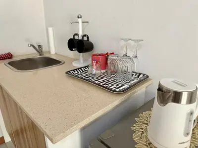 a kitchen counter with a coffee maker on a tray at The Minimalist Suite in Kempton Park