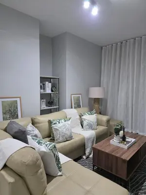 a living room with two couches and a coffee table at Menyln 2 Bedroom Apartment in Pretoria