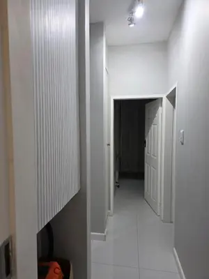 a hallway with white walls and a white door at Menyln 2 Bedroom Apartment in Pretoria
