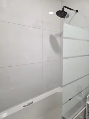 a shower with a glass door in a bathroom at Menyln 2 Bedroom Apartment in Pretoria