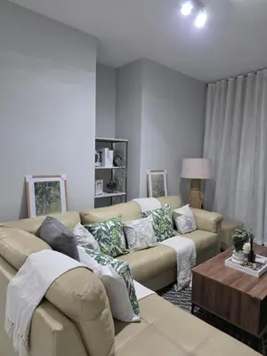 a living room with a couch and a table at Menyln 2 Bedroom Apartment in Pretoria