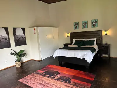 a bedroom with a bed and a rug on the floor at Palm View in White River