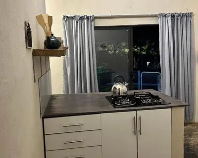 a kitchen with a stove and a counter top at Palm View in White River