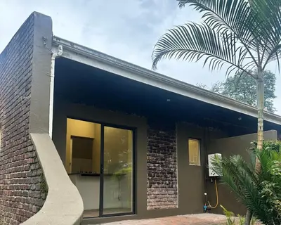 a brick house with a large sliding glass door at Palm View in White River