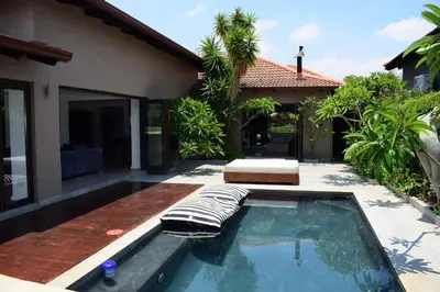 a swimming pool in front of a house at Luxury Stay at The 28 Pecanwood in Hartbeespoort