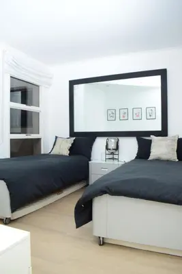 a bedroom with two beds and a large mirror at Luxury Stay at The 28 Pecanwood in Hartbeespoort