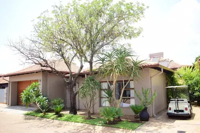 a house with a car parked in front of it at Luxury Stay at The 28 Pecanwood in Hartbeespoort