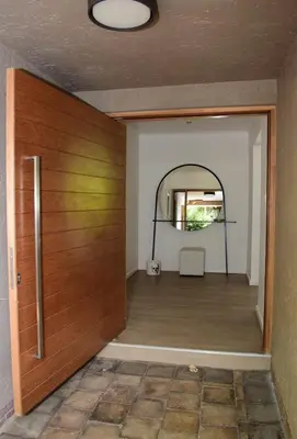 a room with a wooden door and a mirror at Luxury Stay at The 28 Pecanwood in Hartbeespoort