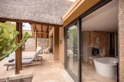 an open bathroom with a tub and a bath tub at Kapama Southern Camp in Kapama Private Game Reserve